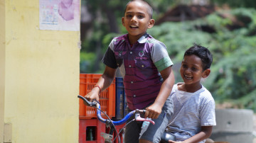Two children ride a bike